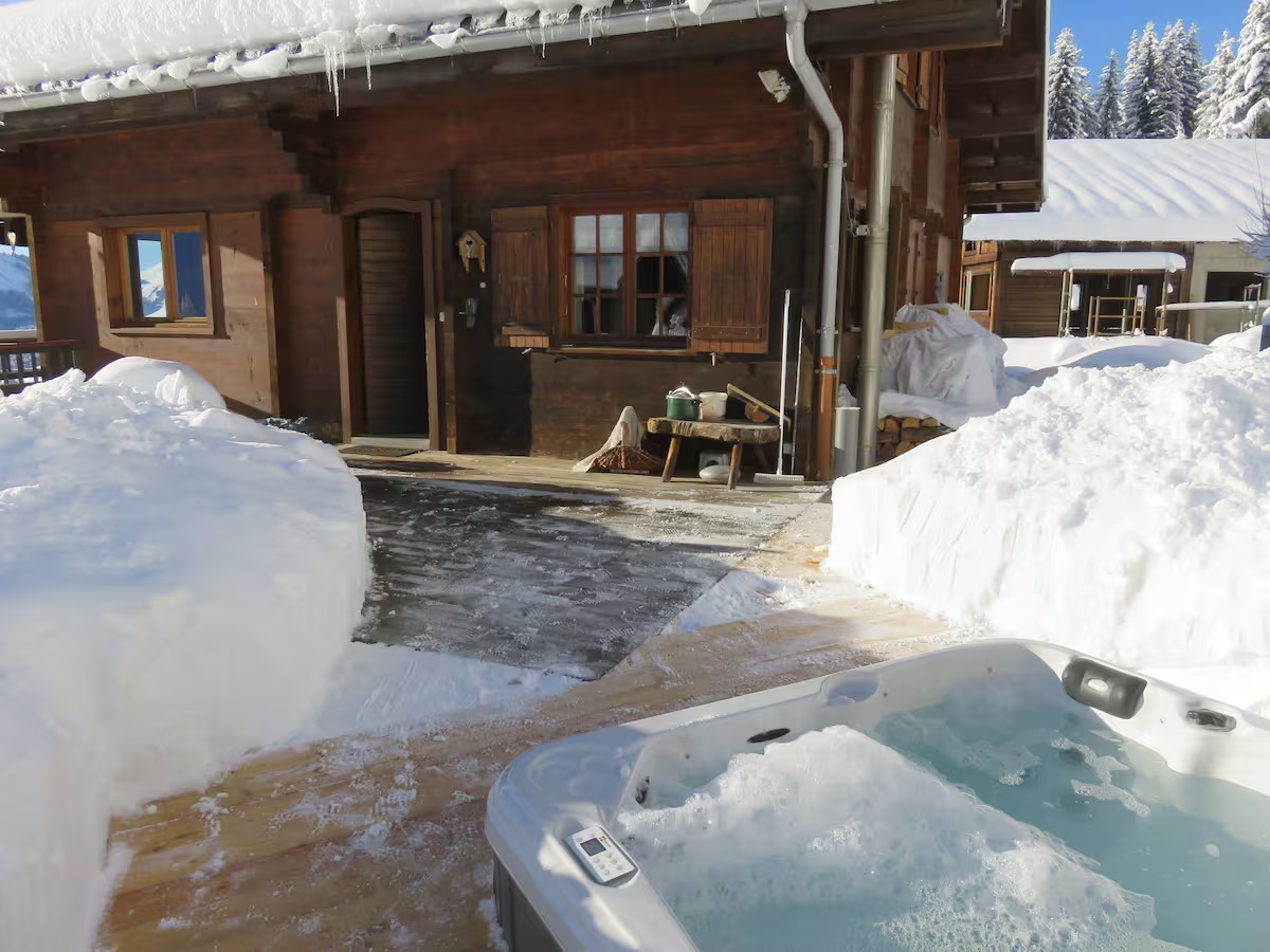 Le jacuzzi au pied du chalet enneigé